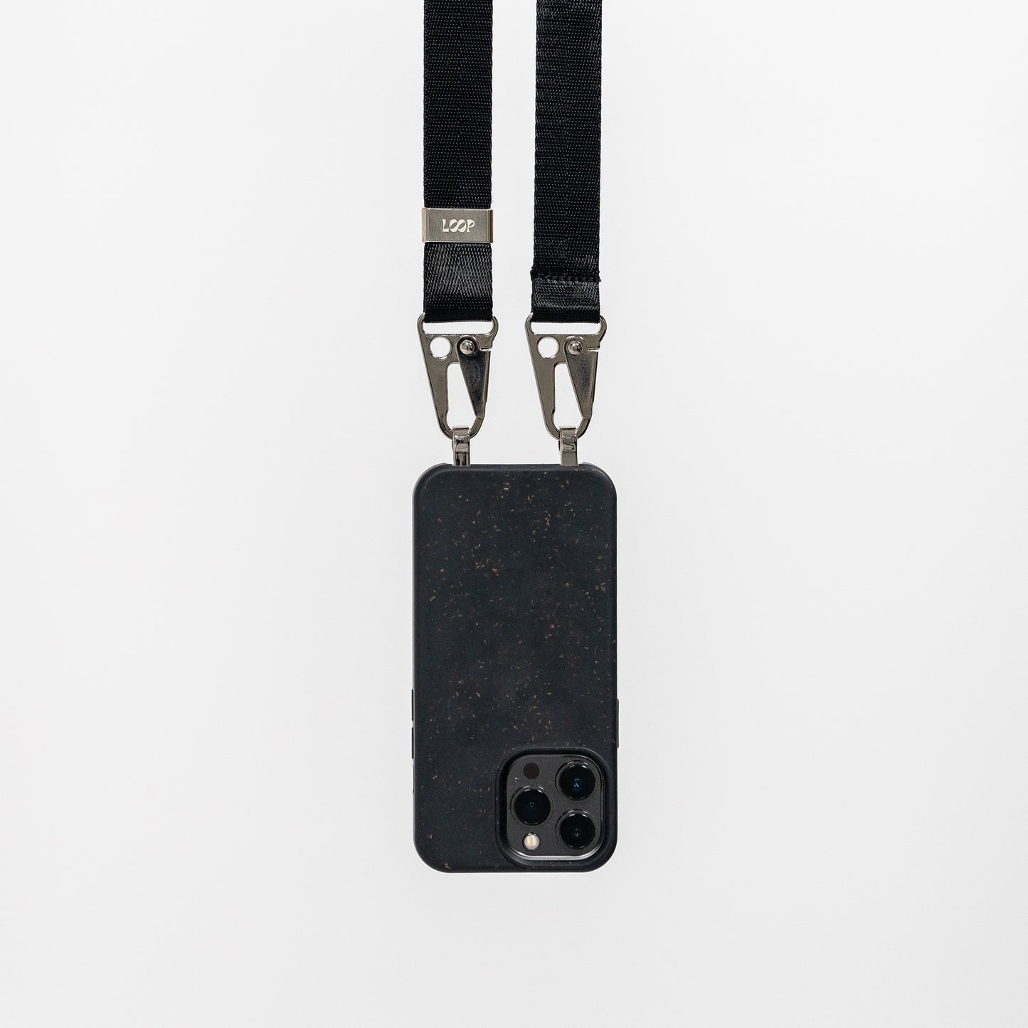 Loop speckled ink crossbody phone case with black phone strap attached hanging 