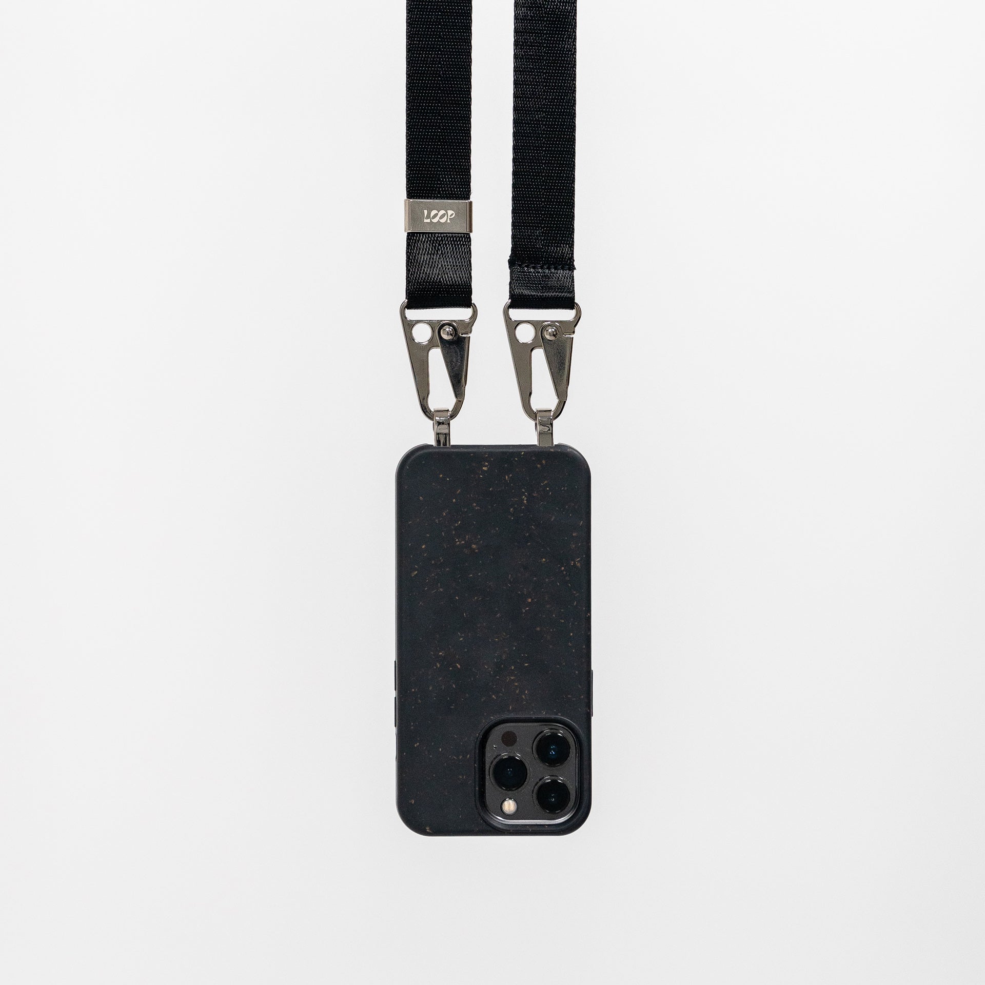 Loop speckled ink crossbody phone case with black phone strap attached hanging 