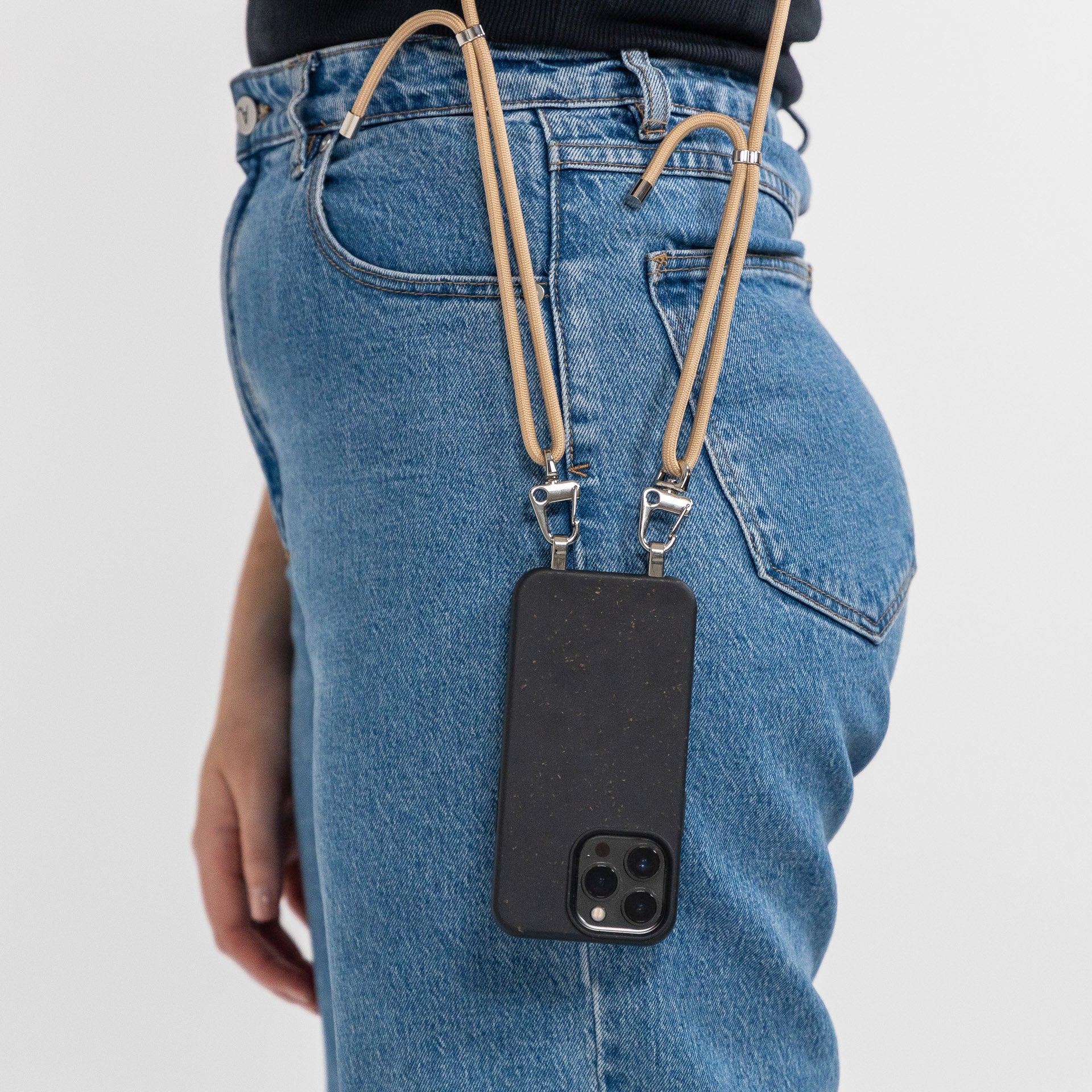 Crossbody phone case ink with tapioca cord side profile hanging down to hip
