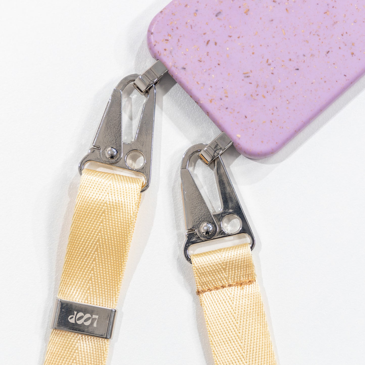 Loop lavender crossbody phone case with butter phone strap attached flat lay face down