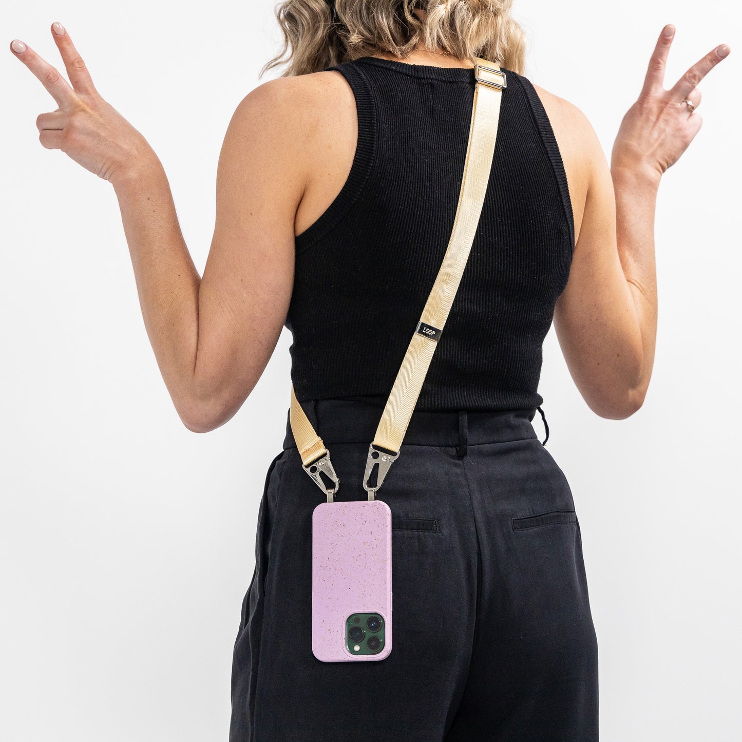 Lavender crossbody phone case with butter phone strap work ver shoulder and on back of model