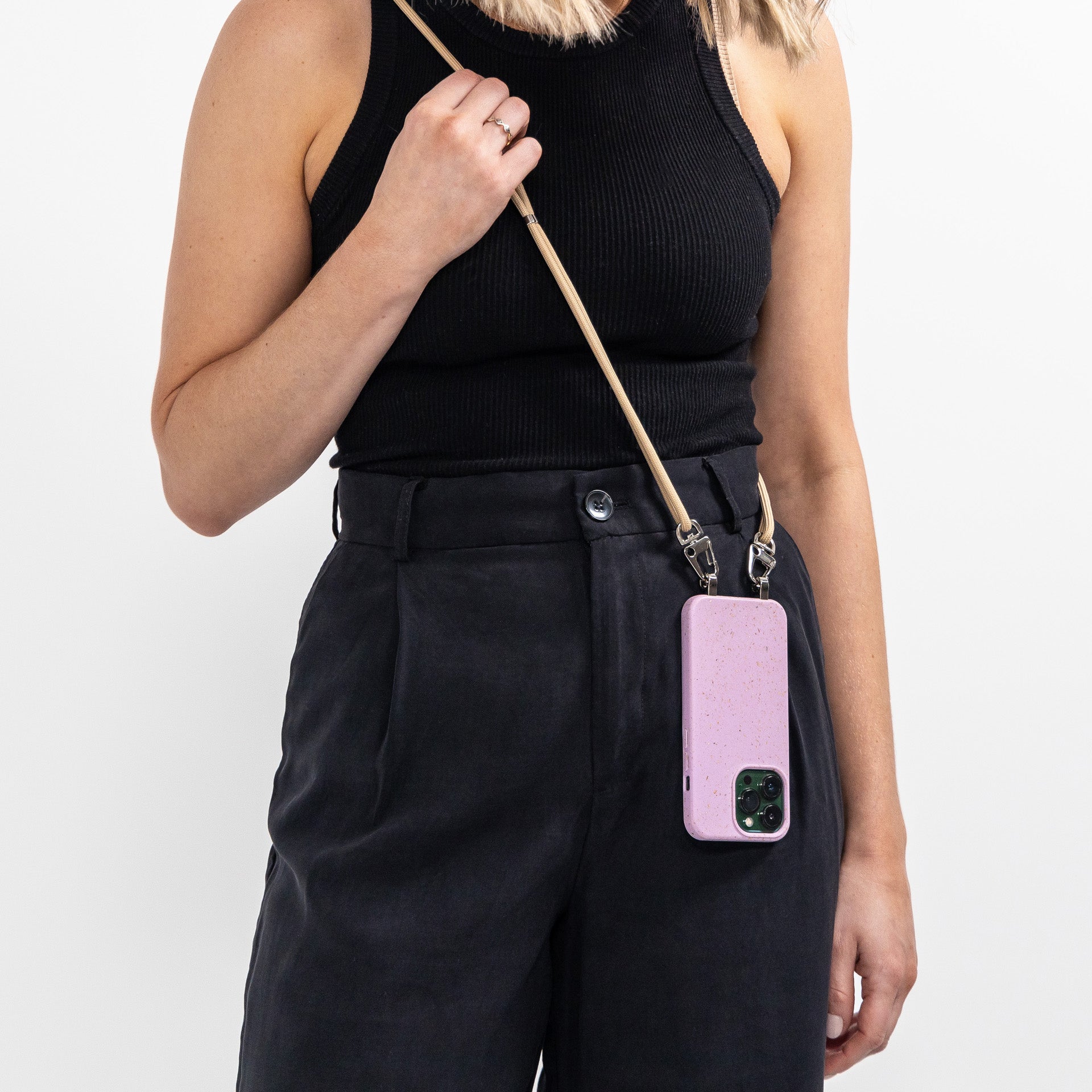 Lavender crossbody phone case with tapioca strap being worn across shoulder