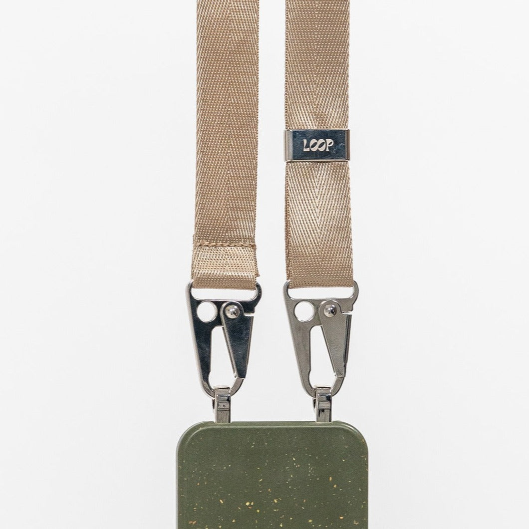 Pesto Loop crossbody phone case with latte strap attached close up hanging