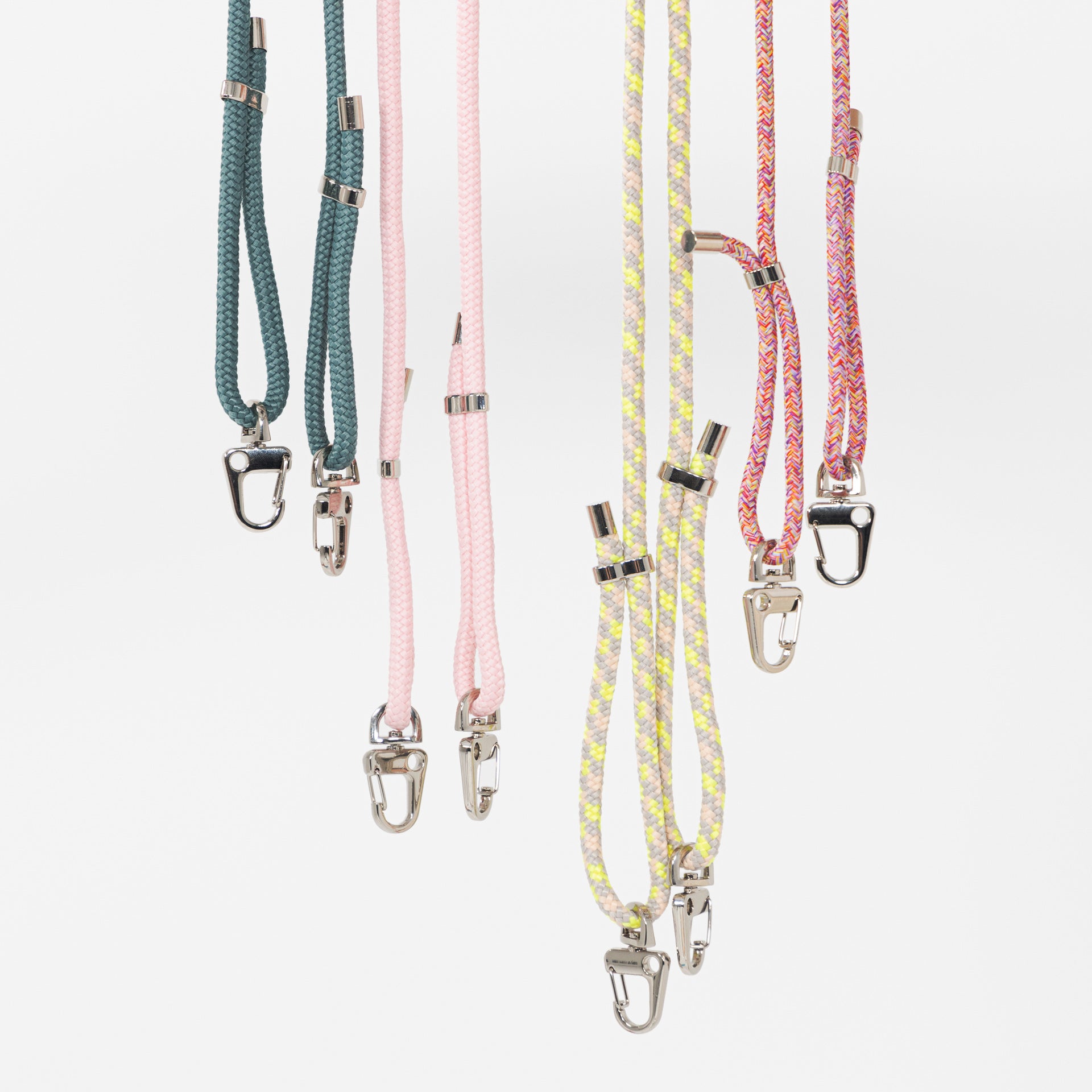 All crossbody phone cords hanging together with no phone cases attached