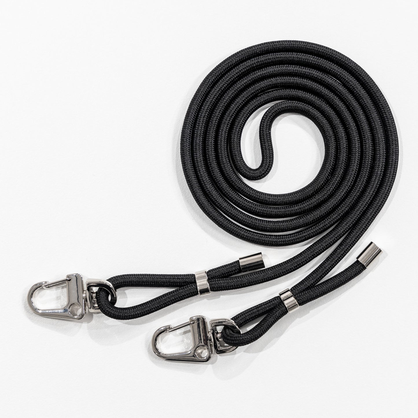 Loop black crossbody cord coiled flat lay