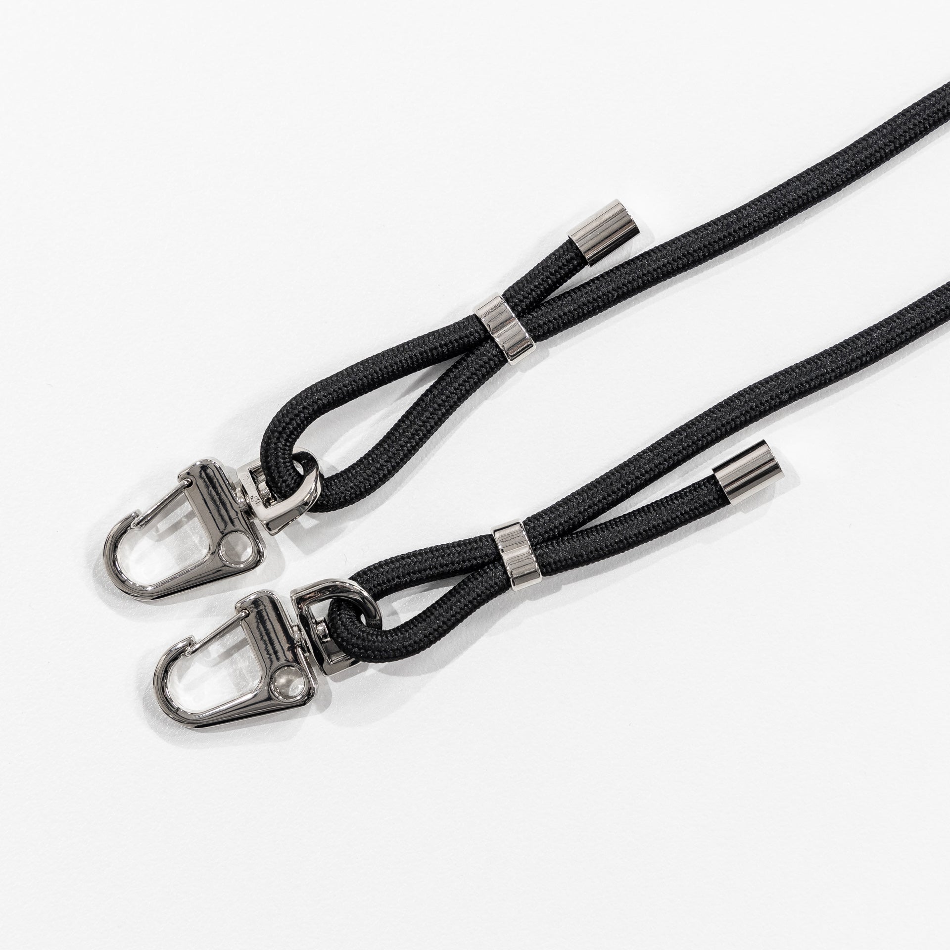 Black crossbody cord with no case attached flat lay