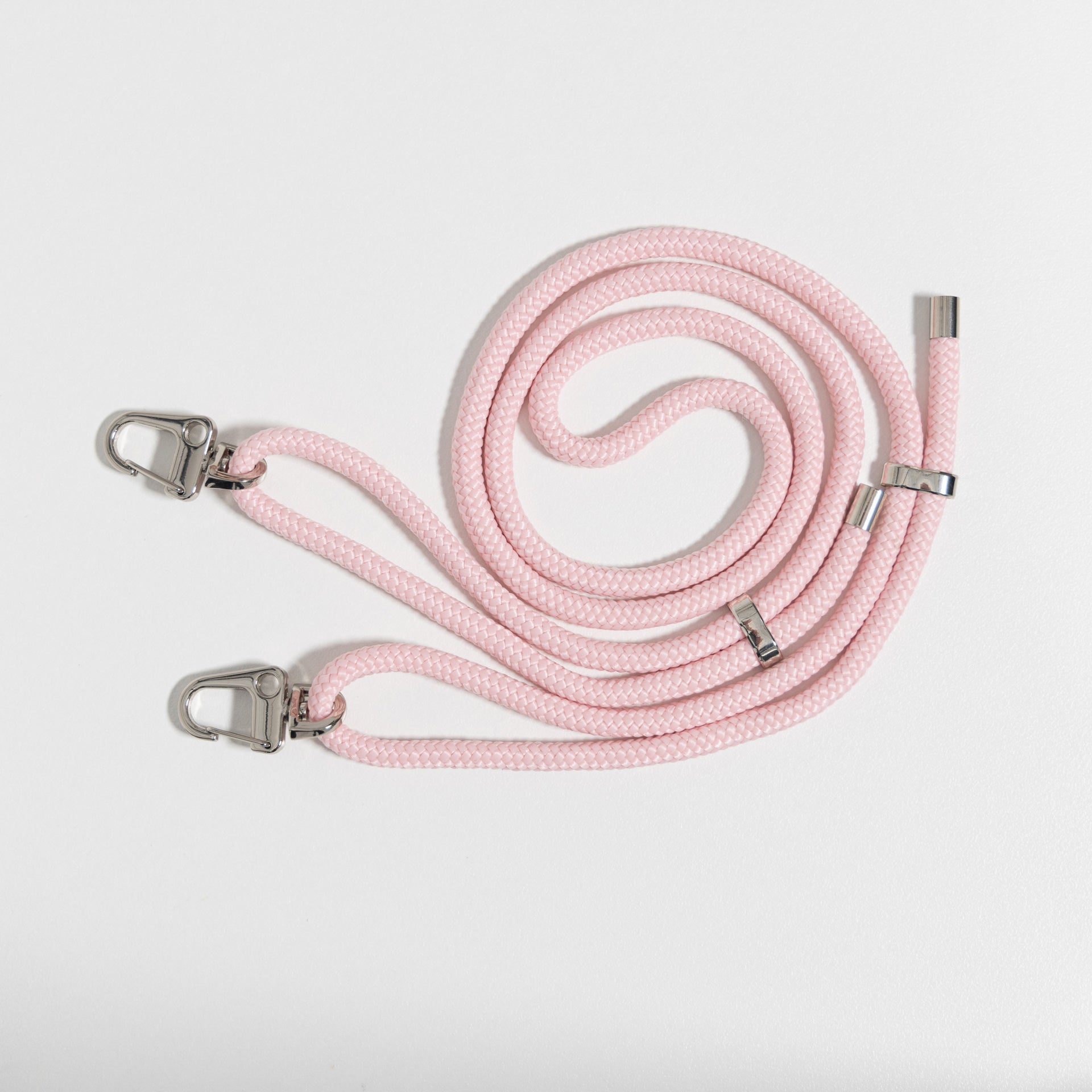 Loop blush crossbody cord coiled up flat lay