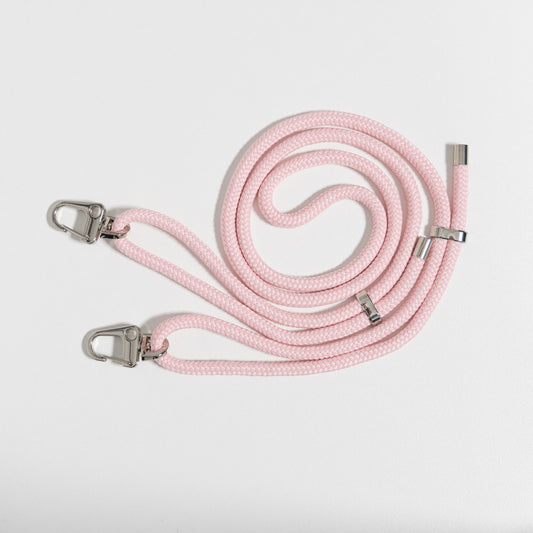 Loop blush crossbody cord coiled up flat lay