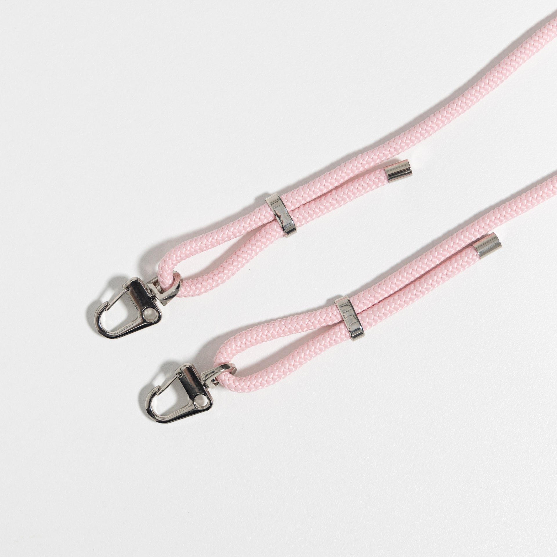 Blush crossbody cord flat lay with no phone case connected