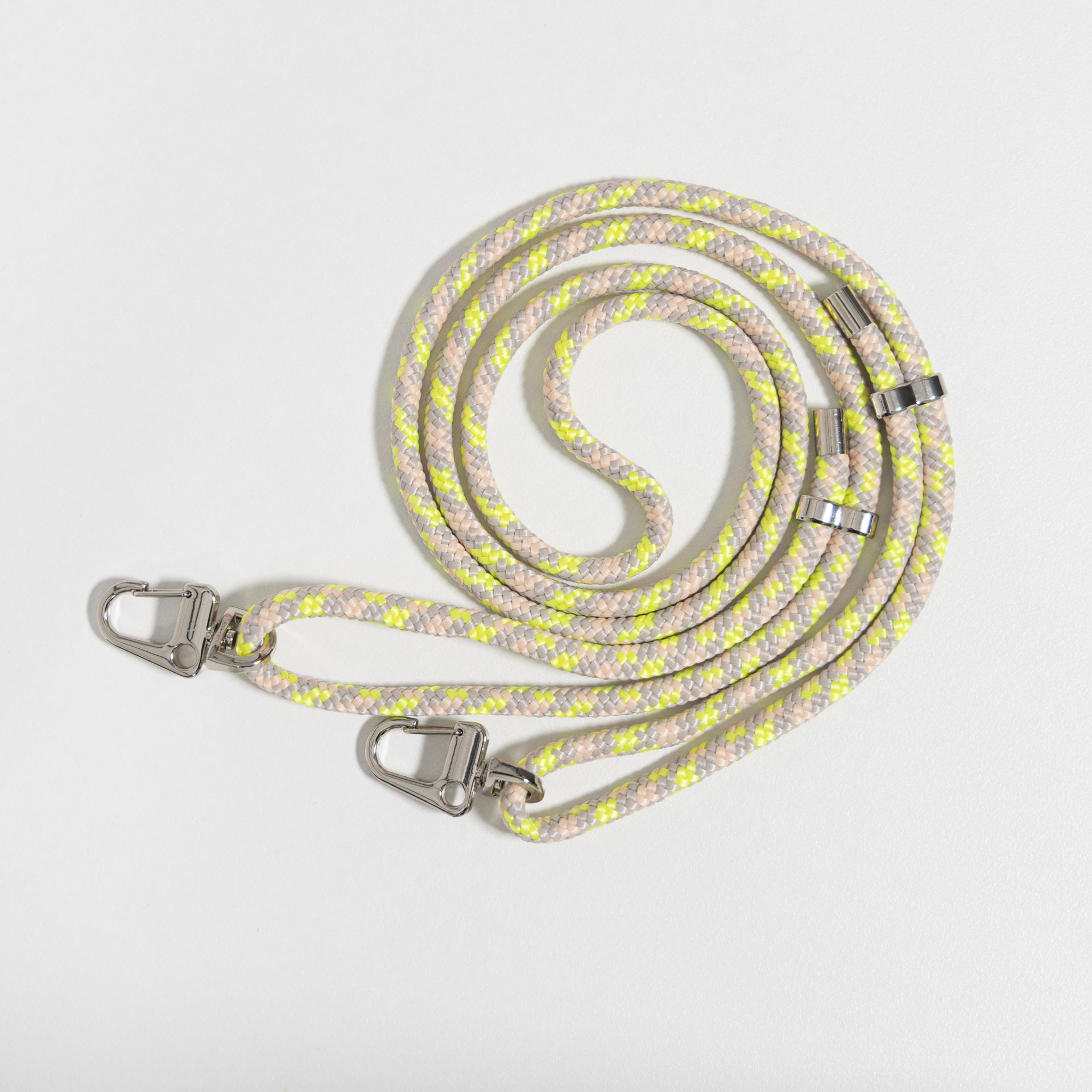 Crossbody cord zest coiled up flat lay