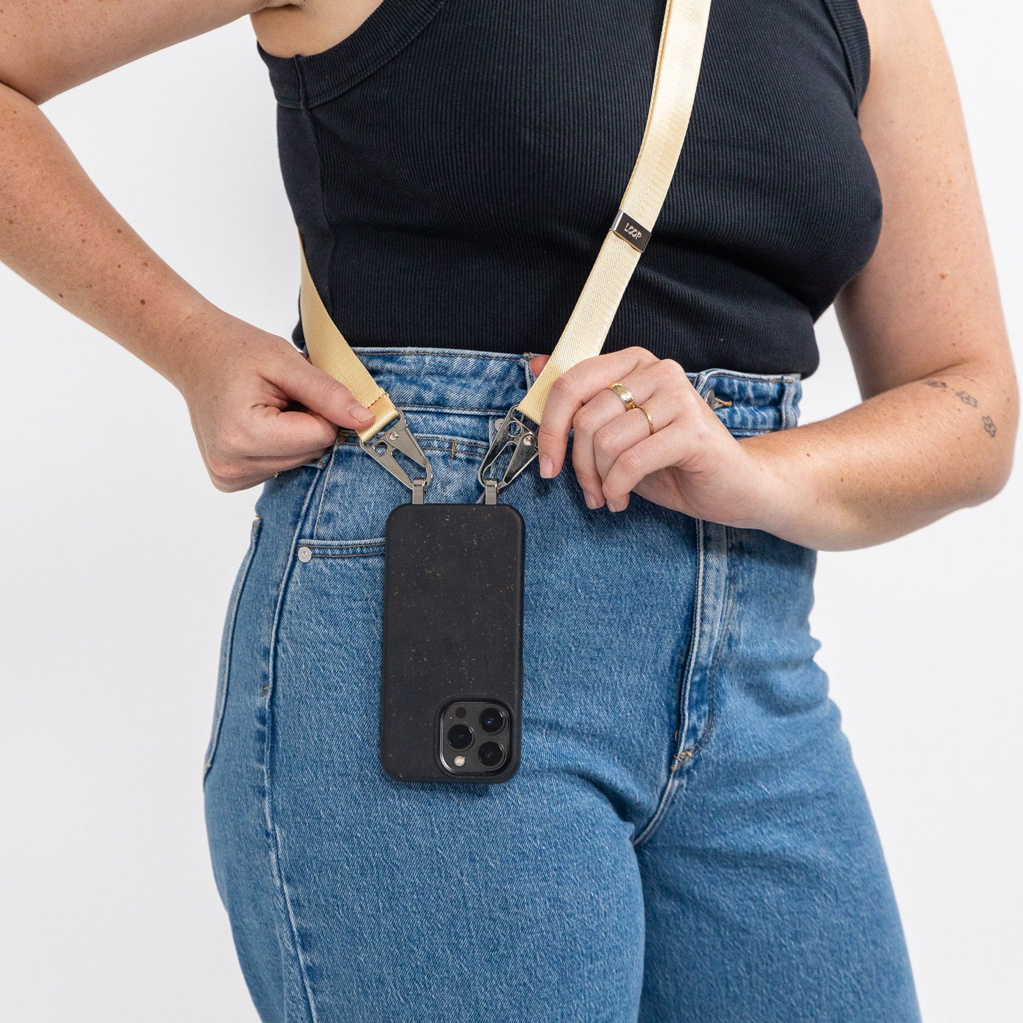Ink crossbody phone case with butter strap being worn over shoulder and on hip
