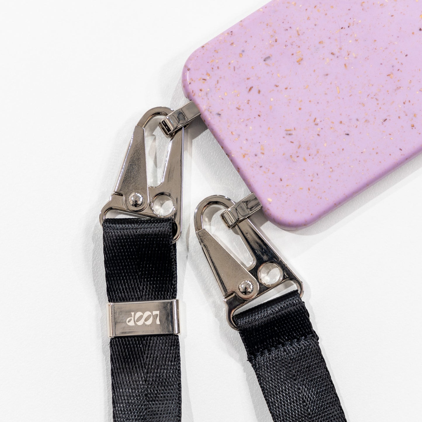 Crossbody phone case lavender with black strap laying flat