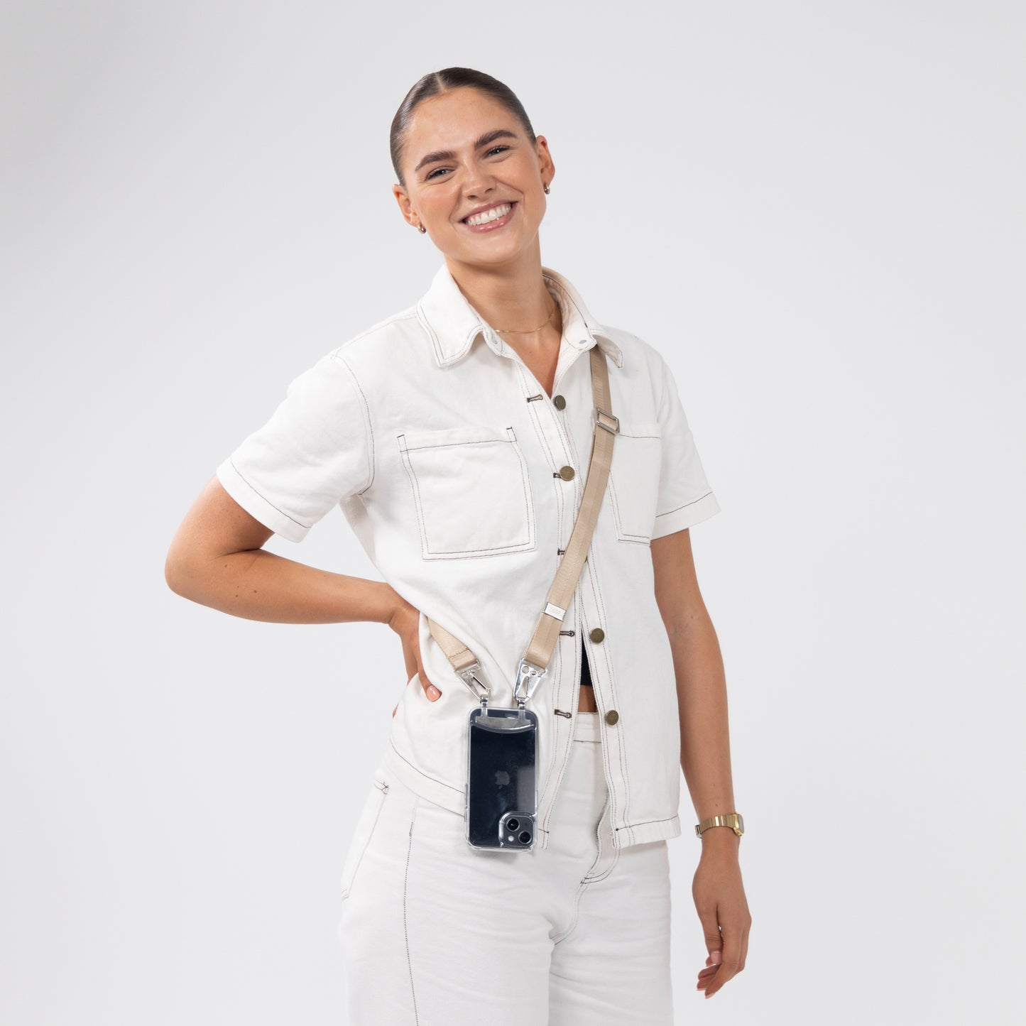 Clear crossbody phone case with latter crossbody strap being worn over shoulder to the front