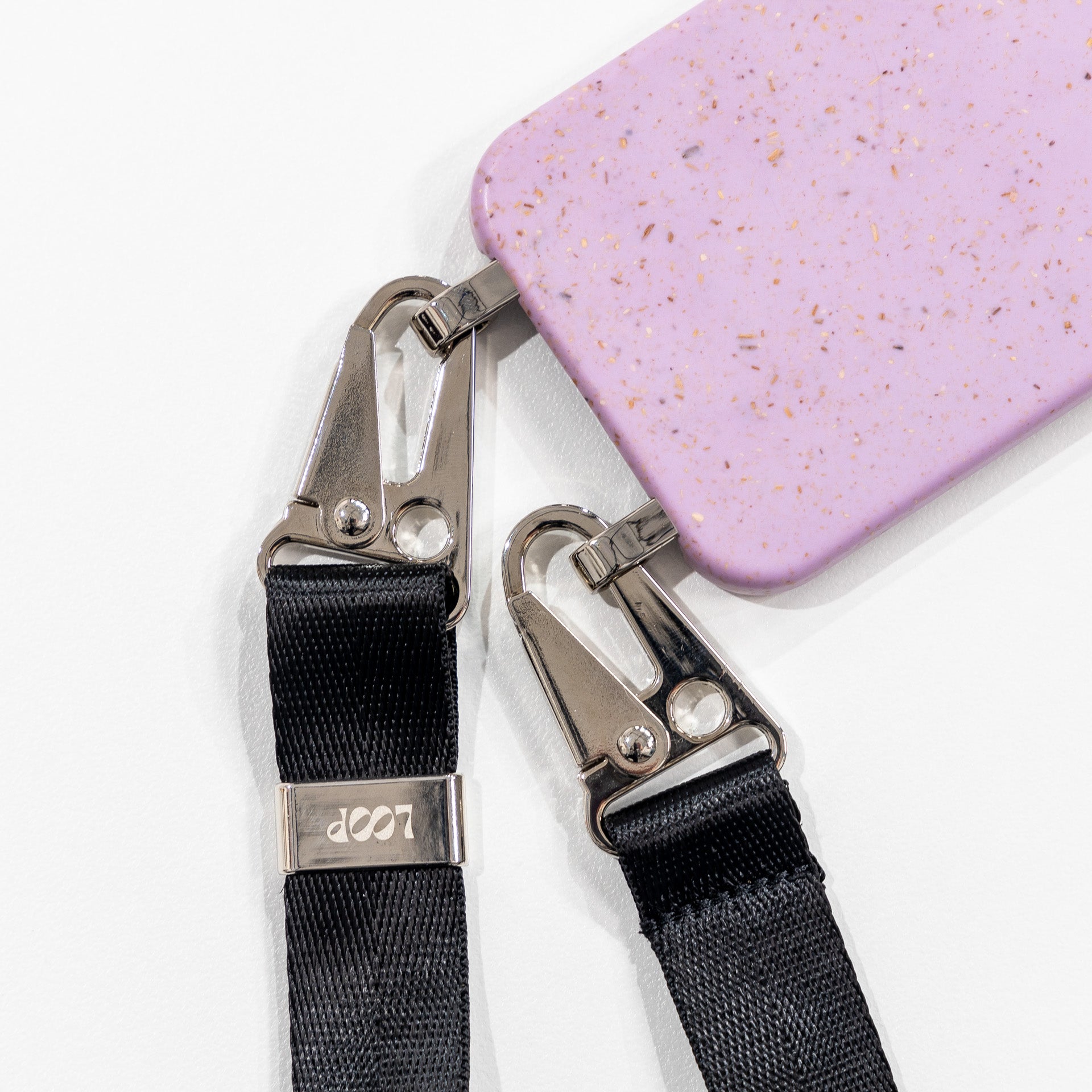 Lavender crossbody phone case flat lay with black strap attached 