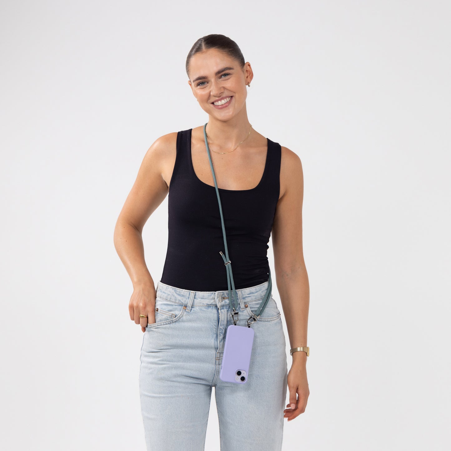 Lilac Loop crossbody phone case with seafoam cord being worn across shoulder by model