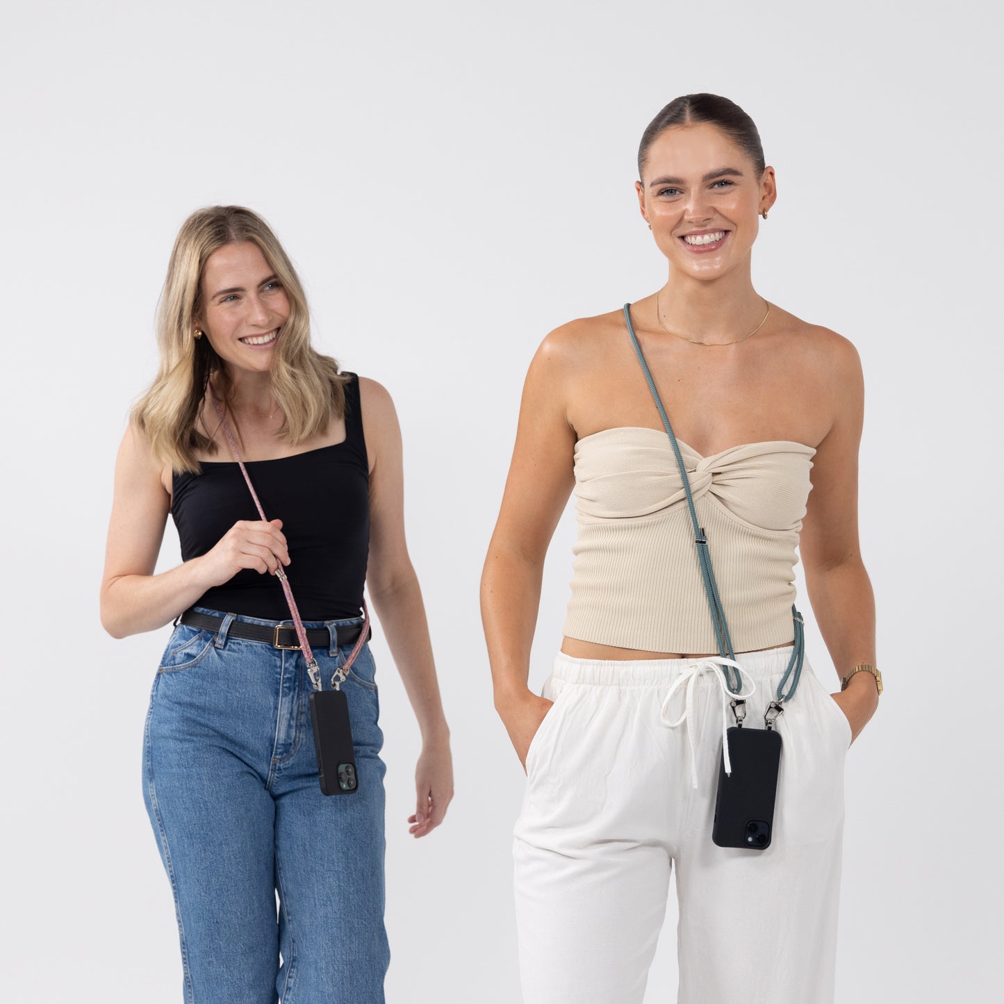 Black crossbody phone case with sangria and seafoam worn by models over shoulder